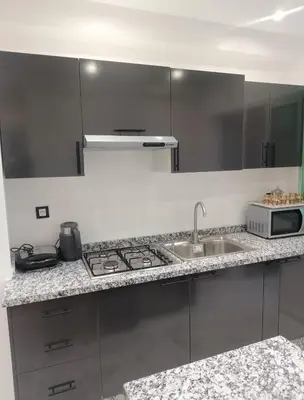 a kitchen with a sink and a microwave at Bright Apartment, 10 minutes from Gueliz and 7 minutes from Majorelle Garden in Marrakech