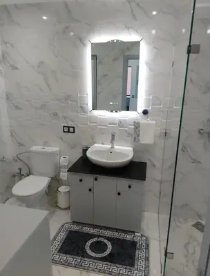 a bathroom with a sink and a toilet and a mirror at Bright Apartment, 10 minutes from Gueliz and 7 minutes from Majorelle Garden in Marrakech