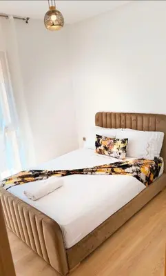 a bed in a bedroom with a wooden floor at Modern 3BR Luxury Prestigia Golf in Marrakech