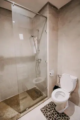a bathroom with a toilet and a glass shower at Modern 3BR Luxury Prestigia Golf in Marrakech