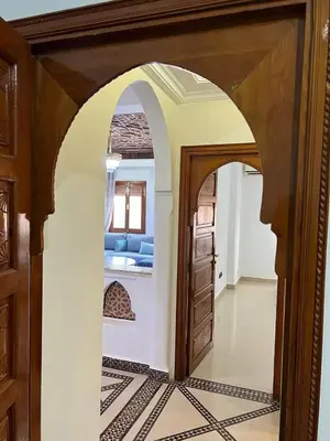 an archway in a room with a living room at Stylish 2-Bedroom City Apartment in the city of Marrakech in Marrakech