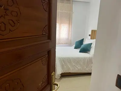a bedroom with a bed and a window at Stylish 2-Bedroom City Apartment in the city of Marrakech in Marrakech