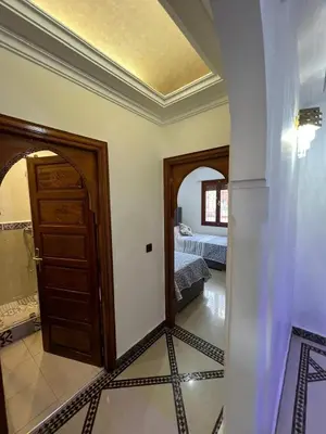 a room with a door and a bedroom with a bed at Stylish 2-Bedroom City Apartment in the city of Marrakech in Marrakech