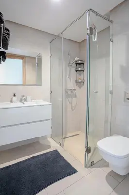 a bathroom with a shower and a toilet and a sink at Noria Marrakech in Marrakech