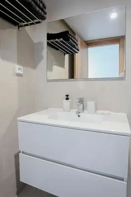 a bathroom with a white sink and a mirror at Noria Marrakech in Marrakech