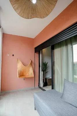 a bedroom with a bed and a large window at Noria Marrakech in Marrakech