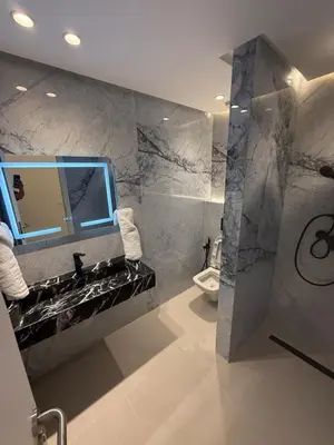 a bathroom with a sink and a mirror and a toilet at Modern Apartment in Jnane Gueliz in Marrakech