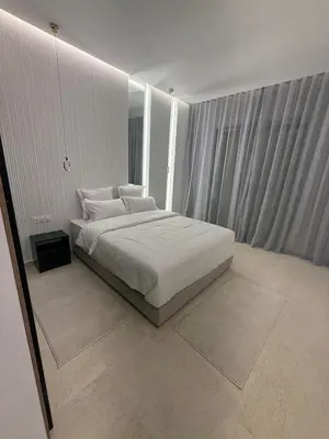 a bedroom with a bed with white sheets and pillows at Modern Apartment in Jnane Gueliz in Marrakech