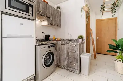 a kitchen with a washing machine and a washer at Charming Studio Center, Quiet, Well Placed in Marrakech