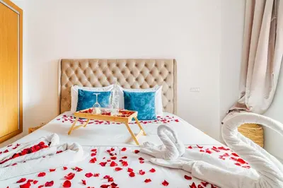 a bedroom with a bed with red flowers on it at Charming Studio Center, Quiet, Well Placed in Marrakech