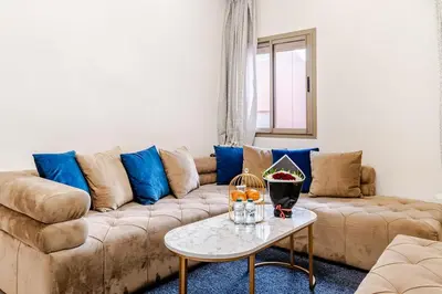 a living room with a couch and a table at Charming Studio Center, Quiet, Well Placed in Marrakech