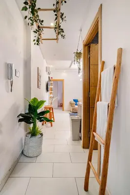 a hallway with a chair and a plant at Charming Studio Center, Quiet, Well Placed in Marrakech