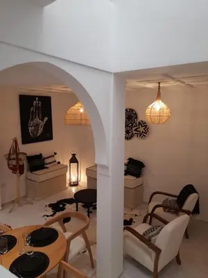a living room with a table and chairs at Riad Douiria MiLa Luxury Private 2 to 4 people in Marrakech