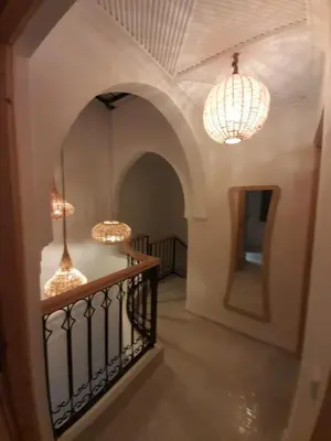 a hallway with two chandaliers and two lights at Riad Douiria MiLa Luxury Private 2 to 4 people in Marrakech