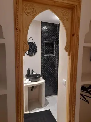 a bathroom with a sink and a shower with a mirror at Riad Douiria MiLa Luxury Private 2 to 4 people in Marrakech