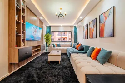 a living room with a couch and a tv at Central Luxury Gem marrakech 3BR in Marrakech
