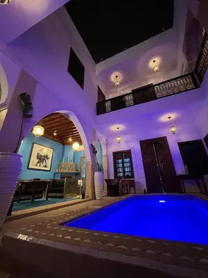 a swimming pool in a house with purple lighting at Entire Boutique Riad with 5star Hospitality Breakfast included in Marrakech