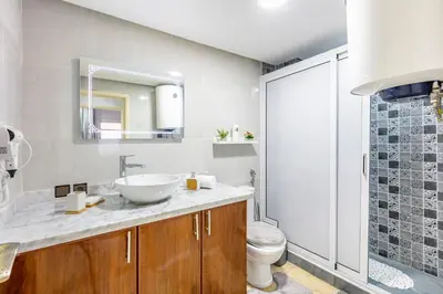 a bathroom with a sink and a toilet and a mirror at Cocon Urbain centre-ville et confort in Marrakech
