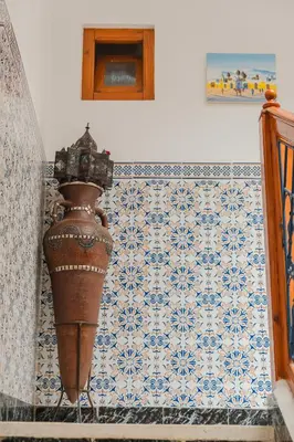 a vase sitting on the corner of a room with a wall at Riad Palm Oasis Marrakech in Marrakech
