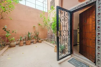 an open door to a courtyard with potted plants at Riad Palm Oasis Marrakech in Marrakech