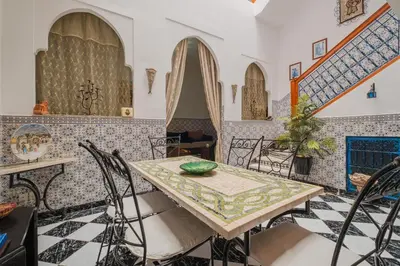 a dining room with a table and chairs at Riad Palm Oasis Marrakech in Marrakech