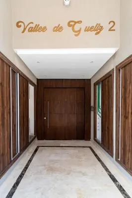 a hallway with wooden doors and a sign that reads value do c well at Central Victor Hugo Studio near Gueliz Wi-Fi in Marrakech