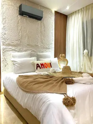 a bedroom with a large white bed with a sign on it at Central Victor Hugo Studio near Gueliz Wi-Fi in Marrakech