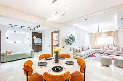 a living room with a table and chairs at Appartement Élégant Quartier Hivernage in Marrakech