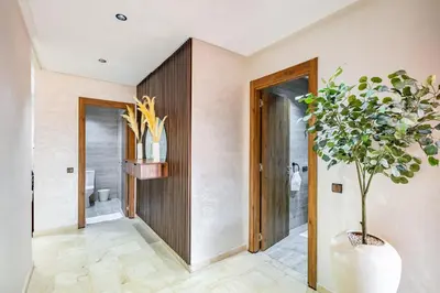 a bathroom with a potted plant in the corner at Appartement Élégant Quartier Hivernage in Marrakech