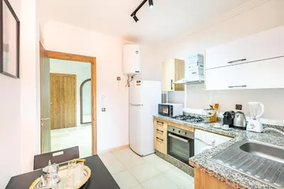a kitchen with a sink and a counter top at Appartement Élégant Quartier Hivernage in Marrakech