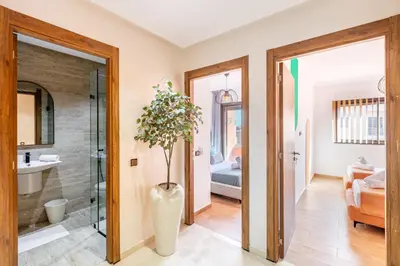 a bathroom with a shower and a vase with a plant at Appartement Élégant Quartier Hivernage in Marrakech