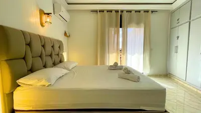 a large bed in a room with a window at Très belle appartement à Gueliz in Marrakech