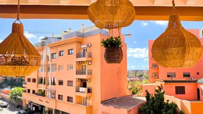 a view from the balcony of a building with hanging baskets at Très belle appartement à Gueliz in Marrakech