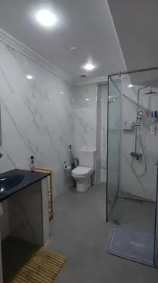 a bathroom with a shower and a toilet and a sink at Très belle appartement à Gueliz in Marrakech