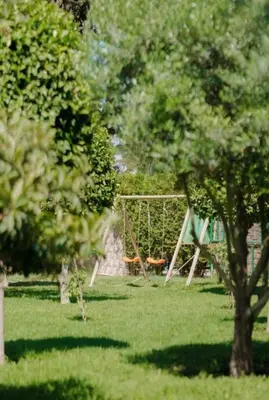 a park with a swing set in the grass at Palmeraie Cozy Apartment in Marrakech
