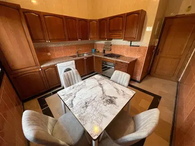 an overhead view of a kitchen with a table and chairs at Palmeraie Cozy Apartment in Marrakech