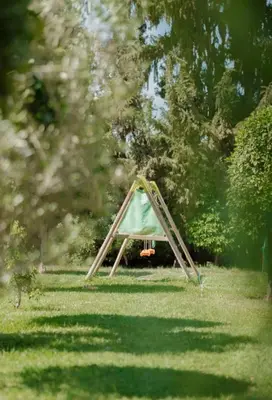 a triangle tent in the grass in a field at Palmeraie Cozy Apartment in Marrakech