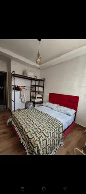 a bedroom with a bed with a red head board at Casa della calma in Marrakech