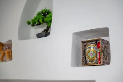 a small plant is next to a picture on a wall at Appartement 3 Chambres Luxe au Cœur de Guéliz in Marrakech