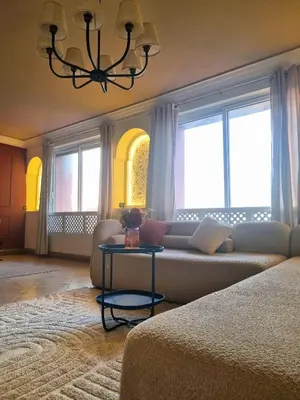 a living room with a couch and a table at BOHO Marrakech Medina in Marrakech