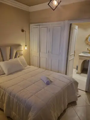 a bedroom with a large white bed and a table at BOHO Marrakech Medina in Marrakech