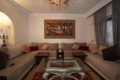 a living room with a couch and a table at Superbe Appartement 3 pieces à Majorelle in Marrakech