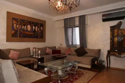 a living room with a couch and a table at Superbe Appartement 3 pieces à Majorelle in Marrakech