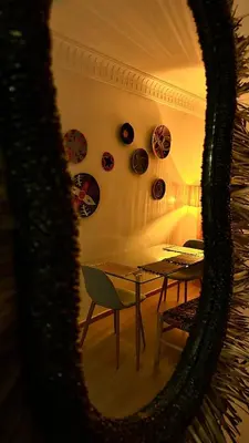 a table and chairs in a room with a mirror at Serenity Loft in Marrakech