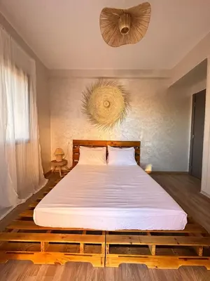 a bedroom with a large bed with white sheets at Serenity Loft in Marrakech