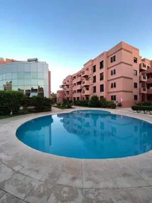 an empty swimming pool in front of a building at Serenity Loft in Marrakech