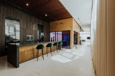 a kitchen with green stools at a counter at Villa Marrakech, Piscine Privée, Sauna et Gym in Marrakech