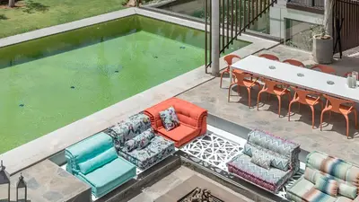 an overhead view of a pool with chairs and a table at Villa Marrakech, Piscine Privée, Sauna et Gym in Marrakech