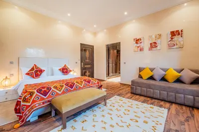 a bedroom with a bed and a couch at Villa Targaït - Luxury villa in Marrakech bliss in Marrakech