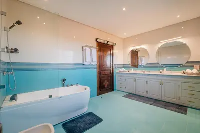 a large bathroom with a tub and two sinks at Villa Targaït - Luxury villa in Marrakech bliss in Marrakech